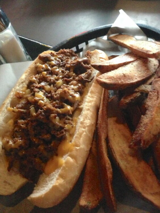 Philly Cheesesteak with hand-cut Potato Wedges from Oblivion Taproom in Orlando, Florida