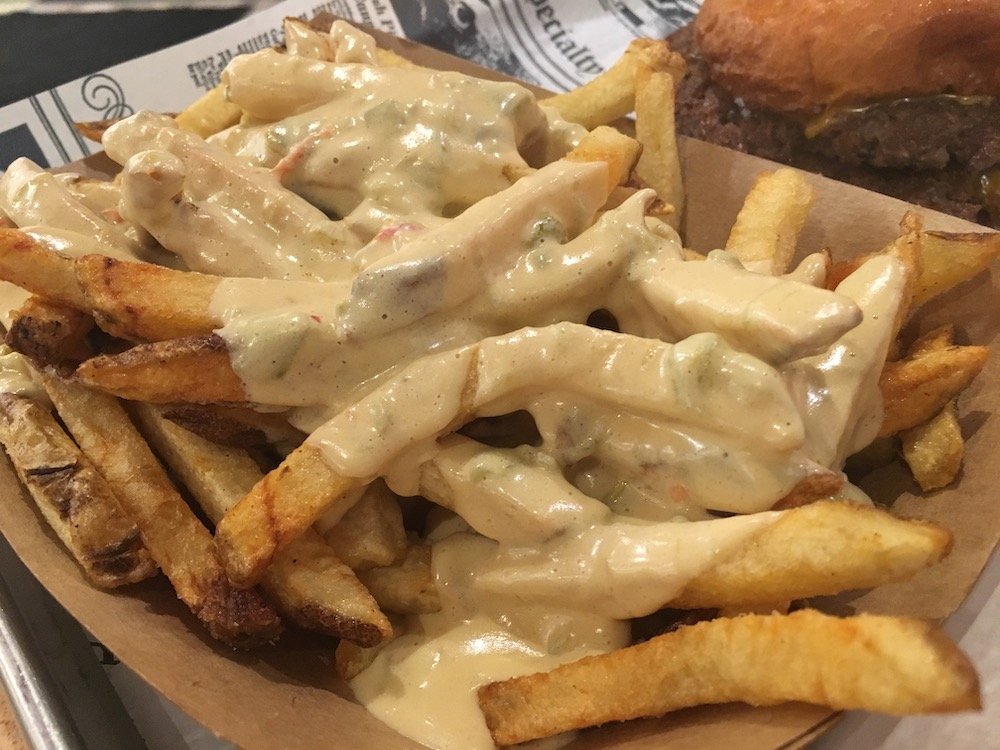 Fresh-cut Fries topped with Green Chile Queso Sauce