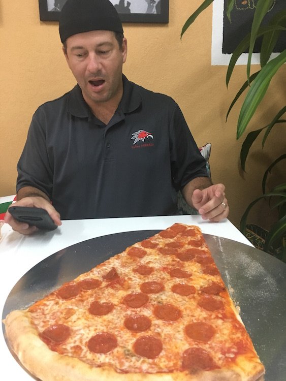 Zavier in awe of the 2 ft Pizza Slice
