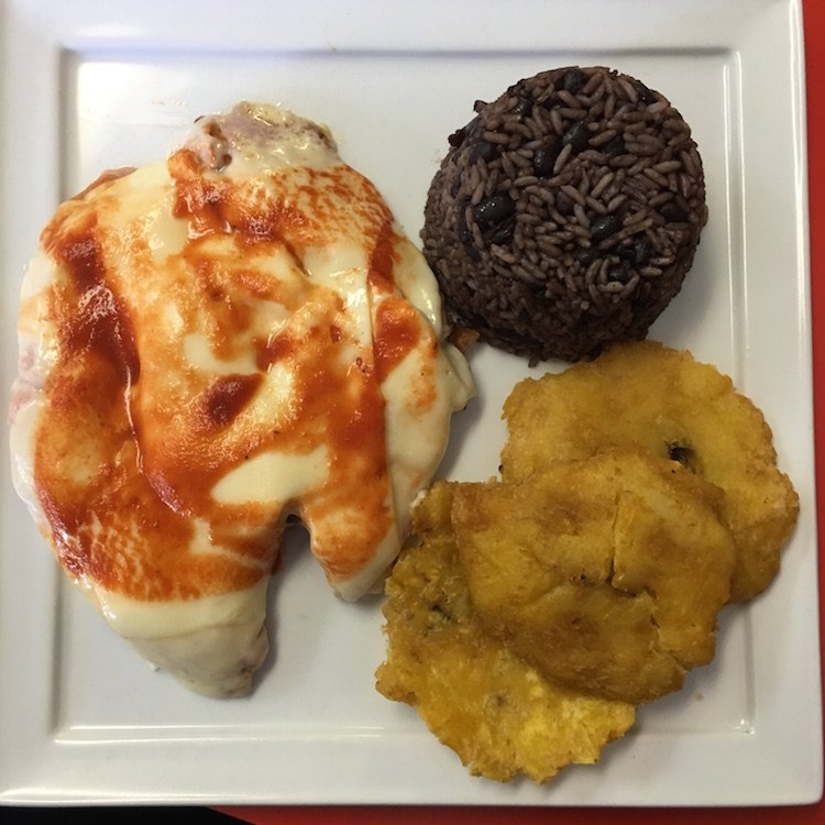 Top shot of the Pollo ala Milanesa, Moros, and Tostones from Odaly's Delight Cafe in Westchester, Florida